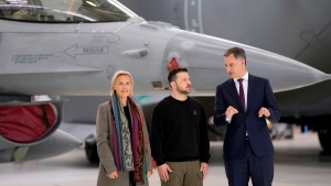 Belgium's Prime Minister Alexander De Croo, right, and Belgium's Defense Minister Ludivine Dedonder, left, pose with Ukraine's President Volodymyr Zelenskyy in front of an F-16 at Melsbroek military airport in Brussels, on May 28, 2024. (AP Photo/Virginia Mayo, File)