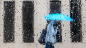 A pedestrian walks during a rainy day. THE CANADIAN PRESS/Nathan Denette