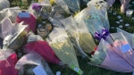 Floral tributes at Stowlawn playing fields in Wolverhampton, left following the killing of Shawn Seesahai in November 2023. (Matthew Cooper / Press Association / AP via CNN Newsource)