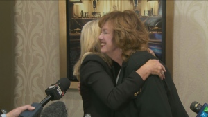 Bonnie Crombie and Carolyn Parrish share a hug following Parrish's win in Mississauga's mayoral byelection. (CP24)