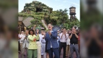 With Princess Tiana, Walt Disney World president Jeff Vahle cheers employees during a "Thank You Fête" honoring cast members at a preview event for Tiana's Bayou Adventure at the Magic Kingdom in Bay Lake, Fla., Monday, June 10, 2024. .(Joe Burbank/Orlando Sentinel via AP)
