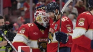Florida Panthers goaltender Sergei Bobrovsky (72) and center Kevin Stenlund (82) celebrate at the end of the third period of Game 2 of the NHL hockey Stanley Cup Finals, Monday, June 10, 2024, in Sunrise, Fla. (AP Photo/Wilfredo Lee)
