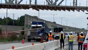 The QEW is closed in both directions in Mississauga this morning after a dump truck struck a pedestrian bridge under construction. (OPP/ X)