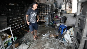 The owner of a pet shop surveys damage after a fire at Chatuchak Weekend Market, one of the most famous markets in Bangkok, Thailand, Tuesday, June 11, 2024. (Sakchai Lalit / AP Photo)