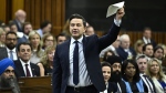 Conservative Leader Pierre Poilievre waves a document in the air as he rises during Question Period in the House of Commons on Parliament Hill in Ottawa on Wednesday, June 5, 2024. THE CANADIAN PRESS/Justin Tang