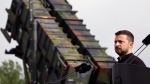 Ukraine's President Volodymyr Zelenskyy stands in front of a Patriot air defense missile system during a visit to a military training area in the German state of Western Pomerania, Tuesday, June 11, 2024. (Jens Buettner/dpa via AP)