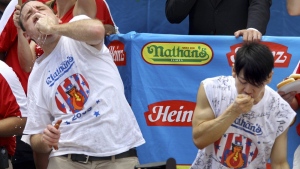 FILE - Joey Chestnut, defending champion of the Nathan’s Famous Fourth of July hot dog eating contest, left, works to outpace former champion Takeru Kobayashi, right, July 4, 2009, in New York. Chestnut, a 16-time hot dog-eating champion, will face off with his frequent Nathan’s competitor, Kobayashi, in a live Netflix special on Sept. 2, 2024, the streamer announced Wednesday, June 12. (AP Photo/Craig Ruttle, File)