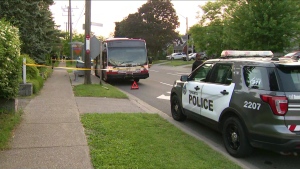 A police cruiser is parked in front of a stopped TTC bus after a stabbing on Wednesday, June 12, 2024. (CP24)
