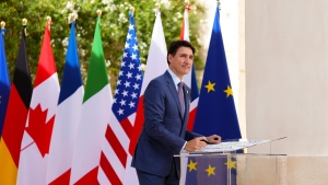 Prime Minister Justin Trudeau signs a G7 poster as he arrives to the G7 Summit in Savelletri Di Fasano, Italy on Thursday, June 13, 2024. THE CANADIAN PRESS/Sean Kilpatrick