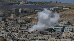 Smoke rises in the Palestinians Al Fara'a refugee camp in the occupied West Bank following an Israeli military raid, June 10, 2024. (AP Photo/Majdi Mohammed)