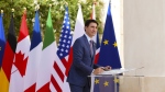 Prime Minister Justin Trudeau signs a G7 poster as he arrives to the G7 Summit in Savelletri Di Fasano, Italy on Thursday, June 13, 2024. THE CANADIAN PRESS/Sean Kilpatrick
