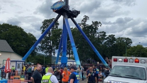 In this photo provided by Oregon Amusement Ride-Rescue and posted on their X account, first responders arrive at Oaks Park for a ride that is stuck with multiple riders in Portland, Ore., June 14, 2024. (Courtesy of Oregon Amusement Ride-Rescue via AP)
