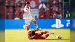 Toronto FC midfielder Alonso Coello (14) leaps over Chicago Fire defender Allan Arigoni (27) during first half MLS soccer action in Toronto on Saturday, June 15, 2024. THE CANADIAN PRESS/Cole Burston
