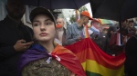 A soldier attends a Pride march in Kyiv, Ukraine, Sunday, June 16, 2024. (AP Photo/Efrem Lukatsky)