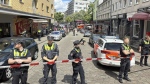Police cordon off an area near the Reeperbahn in Hamburg, Germany, Sunday, June 16, 2024. German police say officers have shot and wounded a man who was threatening them with an axe and a firebomb in the northern city of Hamburg, hours before the city hosts a match in the Euro 2024 soccer tournament. (Steven Hutchings/dpa via AP)