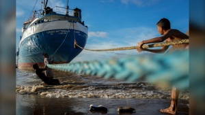 Children play with the ropes of a ship docked on a beach in Parika, Guyana, Sunday, June 9, 2024. (AP Photo/Ramon Espinosa)
