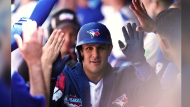 Toronto Blue Jays' Daulton Varsho (25) celebrates in the dugout after hitting a grand slam against the Cleveland Guardians during fifth inning American League MLB baseball action in Toronto on Sunday, June 16, 2024. THE CANADIAN PRESS/Chris Young