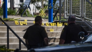 Officials secure the scene of a shooting at the Brooklands Plaza Splash Pad on June 15, 2024. (Katy Kildee/Detroit News via AP)