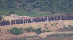 North Korean soldiers work at an undisclosed location near the border area, as seen from a South Korean guard area, in this undated photo provided on Tuesday, June 18, 2024. (South Korea Defence Ministry via AP)