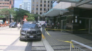 Police are shown at the scene of a stabbing investigation near Yonge and College streets on Tuesday afternoon. (CP24)