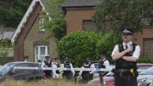 Police officers set up cordon line as a car crashed into a primary school building in Wimbledon, London, Thursday, July 6, 2023.  (AP Photo/Kin Cheung, File)