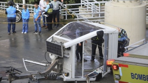A cable car lays on the ground after it fell in Medellin, Colombia, Wednesday, June 26, 2024. At least one person was killed and 12 others were injured when the cable car collapsed while approaching a station, local authorities said. (AP Photo/Fredy Amariles)