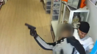 A store employee struggles with an armed robber at a Queen Street West clothing store Sunday June 23, 2024 in this surveillance image obtained by CP24. 