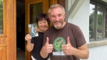 Eva Lim (left) answered the door to Jon Beardmore (right) who was hand delivering a letter from the Galapagos Islands. (Sean Leathong, CTV News)