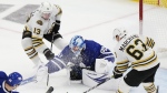 Toronto Maple Leafs' goaltender Joseph Woll (60) makes as save as Boston Bruins' Brad Marchand (63) and Charlie Coyle (13) look for a rebound during third period action in Game 6 of an NHL hockey Stanley Cup first-round playoff series in Toronto on Thursday, May 2, 2024. THE CANADIAN PRESS/Frank Gunn