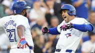 Toronto Blue Jays' George Springer (right) celebrates his three-run home run against the New York Yankees with Vladimir Guerrero Jr. during first inning MLB action in Toronto on Thursday, June 27, 2024. THE CANADIAN PRESS/Frank Gunn