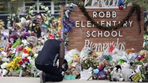 Reggie Daniels pays his respects a memorial at Robb Elementary School, June 9, 2022, in Uvalde, Texas, created to honor the victims killed in the school shooting.  (AP Photo/Eric Gay, File)