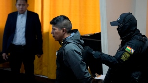 Sergeant Alan Condori is presented to the press in handcuffs by police after his arrest in La Paz, Bolivia, Friday, June 28, 2024. (AP Photo/Juan Karita)