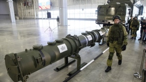 A Russian military officer walks past the 9M729 land-based cruise missile on display in Kubinka outside Moscow, Russia, on Jan. 23, 2019. (AP Photo/Pavel Golovkin, File)