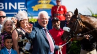 Frank Stronach poses with horse "Holy Helena" of Stronach Stables, after winning the 158th running of the Queen's Plate horse race at Woodbine Race Track, in Toronto on Sunday, July 2, 2017. A court document shows 91-year-old billionaire businessman Stronach stands accused of sexually assaulting seven additional complainants from 1977 to as recently as February.THE CANADIAN PRESS/Mark Blinch