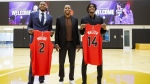 Toronto Raptors draft picks Jonathan Mogbo, left, and Ja’Kobe Walter, pose with Toronto Raptors president Masai Ujiri following a press conference at the OVO Athletic Centre in Toronto, Friday, June 28, 2024. THE CANADIAN PRESS/Cole Burston