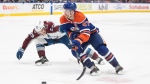 Colorado Avalanche's Nathan MacKinnon (29) and Edmonton Oilers' Connor McDavid (97) battle for the puck during overtime NHL action in Edmonton, Saturday, March 16, 2024. THE CANADIAN PRESS/Jason Franson