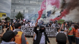Protestors attend a silent march called by the mother of 17-year-old Nahel Merzouk who was killed by police to mark one year since his death, in Nanterre, west of Paris, Saturday, June 29, 2024. (AP Photo/Aurelien Morissard)