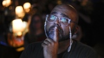 Jocardo Ralston, 47, from Pennsylvania, looks up to a television to watch the presidential debate between President Joe Biden and Republican presidential candidate former President Donald Trump at Tillie's Lounge on Thursday, June 27, 2024, in Cincinnati. (AP Photo/Carolyn Kaster)