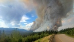 A wildfire is shown from a highway in the Yukon in this handout image provided by Wildland Fire Management/Government of Yukon. THE CANADIAN PRESS/HO-Wildland Fire Management/Government of Yukon *MANDATORY CREDIT*