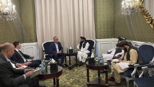 In this photo released by the Taliban Spokesman Office, Zabihullah Mujahid, the chief spokesman for the Taliban government who leads the Taliban delegation, centre right, speaks with Uzbekistan Presidential Envoy to Afghanistan Ismatullah Irgashev, during a meeting in Doha, Qatar, Sunday, June 30, 2024.  (Taliban Spokesman Office via AP)