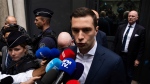 Jordan Bardella, president of the French far-right National Rally party, answers reporters outside the party headquarters, Monday, July 1, 2024 in Paris. (AP Photo/Louise Delmotte)