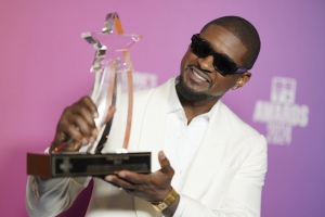 Usher poses with the Lifetime Achievement award in the press room during the BET Awards on Sunday, June 30, 2024, at the Peacock Theater in Los Angeles. (Photo by Jordan Strauss/Invision/AP)