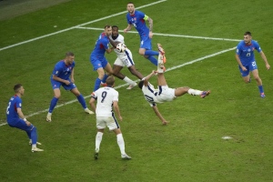 England's Jude Bellingham, centre right, scores his side's first goal with an overhead kick during a round of sixteen match between England and Slovakia at the Euro 2024 soccer tournament in Gelsenkirchen, Germany, Sunday, June 30, 2024. (AP Photo/Ebrahim Noroozi)