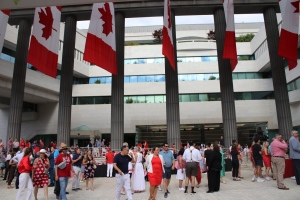 People dressed in red and white ate bacon and pancakes drenched in maple syrup at the Canada Day celebrations at the Embassy of Canada in Washington, D.C., Monday July 1, 2024. (The Canadian Press/Kelly Geraldine Malone)