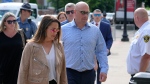 Paul O'Keefe, center, brother of the late Boston police Officer John O'Keefe, enters Norfolk Superior Court with his wife Erin O'Keefe, front left, Monday, July 1, 2024, in Dedham, Mass. (Steven Senne / AP Photo)