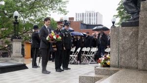 Prime Minister Justin Trudeau (left to right), Major General Paul Peyton, and Chief Warrant Officer Bob McCann attend the wreath laying as an unknown First World War Newfoundland and Labrador soldier is interned at the National War Memorial in St. John's on Monday, July 1, 2024. (The Canadian Press/Paul Daly)