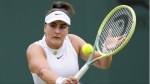 Bianca Andreescu plays a backhand return to Jaqueline Cristian of Romania during their first round match of the Wimbledon tennis championships in London, Monday, July 1, 2024. (The Canadian Press/AP/Kirsty Wigglesworth)