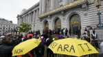 A crowd listens to speakers at a reparations rally outside of City Hall in San Francisco, on March 14, 2023. (AP Photo/Jeff Chiu, File)