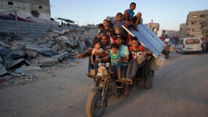 Displaced Palestinians leave an area in east Khan Younis after the Israeli army issued a new evacuation order for parts of the city and Rafah, in the southern Gaza Strip on July 1. (Bashar Taleb/AFP/Getty Images via CNN Newsource)