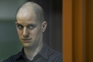 Wall Street Journal reporter Evan Gershkovich stands in a glass cage in a courtroom in Yekaterinburg, Russia, Wednesday, June 26, 2024. (AP Photo)